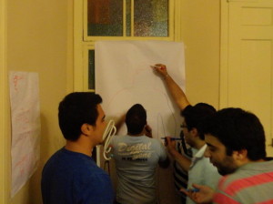 Syrian men and boys affected by GBV participating in a body image and stress management exercises as part of a psycho-social support group session. Photo by Lina Abirafeh.